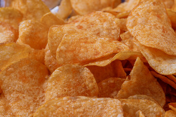 Potato chips or crisps . Close-up of potato chips or crisps. Food background.