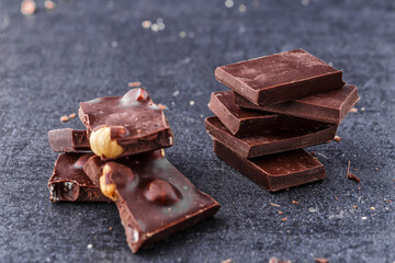 Chocolate cupcake with icing and chocolate bar in Dark lighting,Homemade delicious chocolate muffin on wooden background close-up