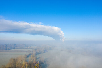 The nuclear power station of Dampierre en Burly in the middle of fields in Europe, in France, in the Center region, in the Loiret, towards Orleans, in Winter, during a sunny day.