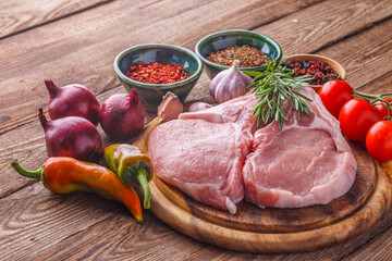 fresh raw new-york steak on wooden Board on wooden background with salt and pepper in a rustic style.