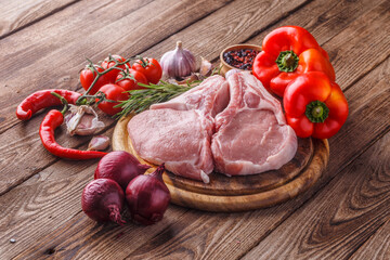 fresh raw new-york steak on wooden Board on wooden background with salt and pepper in a rustic style.