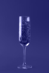 Beautiful card with champagne glass filled with transparent hearts toned in trendy color of year 2022. Love and celebration concept. Great design for any purposes. Closeup.