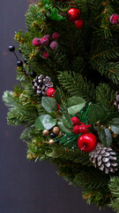 Holiday background of Christmas tree branches, spruce, juniper, fir, larch, pine cones with light. Xmas and New Year theme. Top view, wide composition, seamless pattern