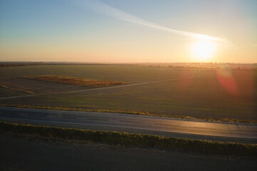 Aerial view of empty intercity road at sunset. Top view from drone of highway in evening