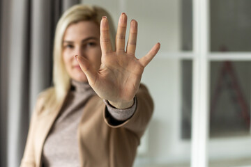 bright picture of young woman making stop gesture