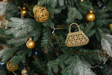 toys hang on the branches of a Christmas tree against the background of flickering garlands. New...