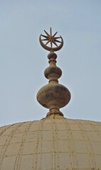 On top of a domed roof of the Alabaster Mosque is special star and crescent symbol. It contains a...