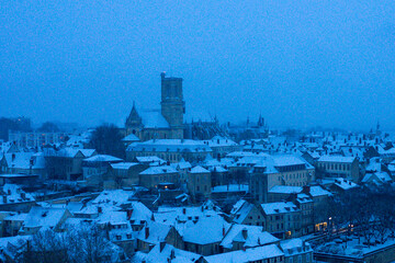 The city center of Nevers under the snow in Europe, France, Burgundy, Nievre, in Winter, during a cloudy evening.