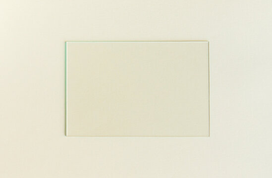 Empty picture frame on a plain background. Blank poster mockup for art display. Pastel color background.