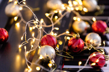 A colorful chain of lights lies on piano keys