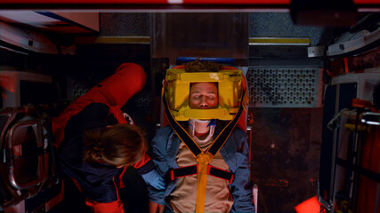 Mixed race ambulance doctors proving medical help to patient after car accident © stockbusters