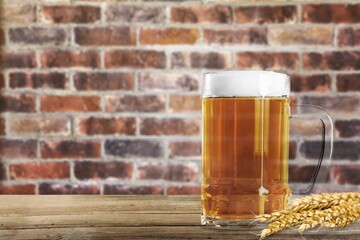 Glass of beer with foam Served in stylish old brick wall interior.