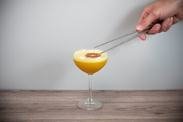hand holding glass of orange juice