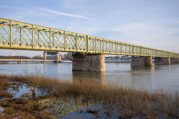 Obraz premium The Sully sur Loire bridge under the snow in Europe, in France, in the Center region, in the Loiret, towards Orleans, in Winter, during a sunny day.