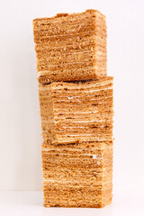 Honey layered cake on white table. Creative concept sweets.