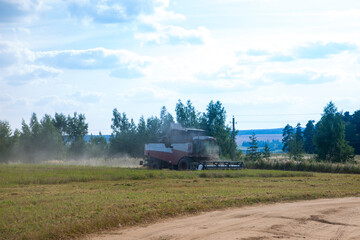 Fototapeta na wymiar Combine harvester harvesting wheat field crop harvest