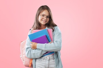Smiling active student schoolgirl holding books and copybooks going to school