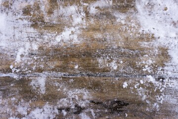 Texture of an old wooden board covered with snow. Winter background with snow and boards.