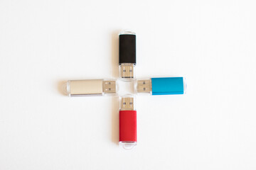 Four USB flash drives in red, silver, black and blue