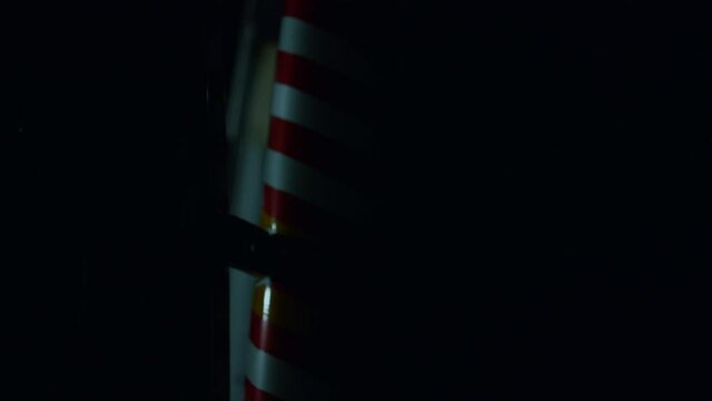 Blue and red emergency lights flashing in dark. Ambulance car parked on street