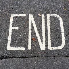 End sign painted on asphalt
