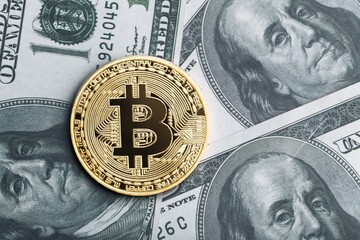Golden symbolic coin Bitcoin on banknotes. Exchange bitcoin cash for a dollars. Cryptocurrency