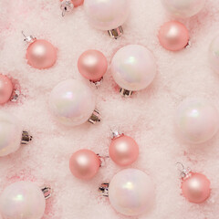 Snowy Christmas background composition with pink decoration . Flat lay. Top view.