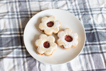 Russian Three flower tea cookies with jam center on plaid tablecloth
