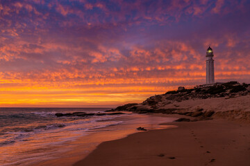 Trafalgar lighthouse on beach at sunset, Canos de Meca, Cadiz, Andalusia, Spain