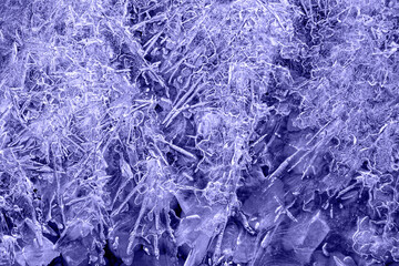 Fototapeta premium blue tint with purple undertone ice patterns on winter glass, ice crystals. abstract background frost close-up Very Peri