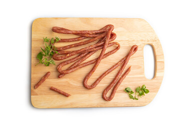 Polish smoked pork sausage kabanos on cutting board isolated on white background. Top view, close up.