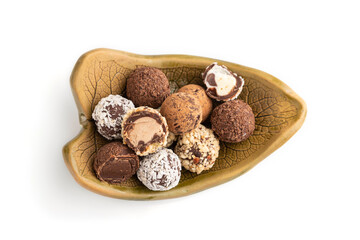Chocolate truffle candies isolated on white background. top view, close up.