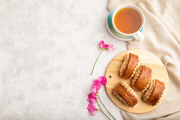 Traditional armenian dessert gata with cup of green tea on a gray concrete background. top view, copy space.