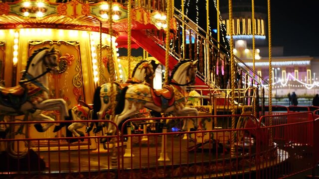 Venetian Merry Go Round Carousel with bright illumination filmed at night in outdoor amusement park