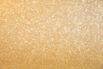 Christmas and new year bokeh lights background. Glitter sparkling abstract gold texture.