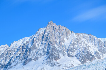 The Aiguille du Midi in the Mont Blanc massif in Europe, France, the Alps, towards Chamonix, in spring, on a sunny day.