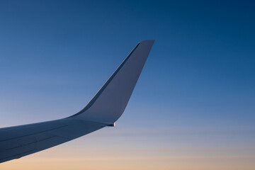 flying and traveling, view from airplane window on the wing on sunset time