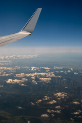 flying and traveling, view from airplane window on the wing on sunset time