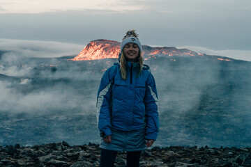tourist looks at Fagradalsfjall, Iceland - June, 2021: volcano eruption near Reykjavik, Iceland