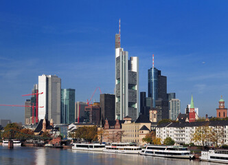 View From The Main River To The Skyline Of The Banker's City Frankfurt Am Main In Hesse Germany On A Beautiful Autumn Day With A Clear Blue Sky And A Few Clouds