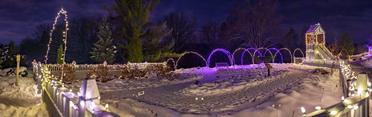 Winter park fence at night with Christmas lights