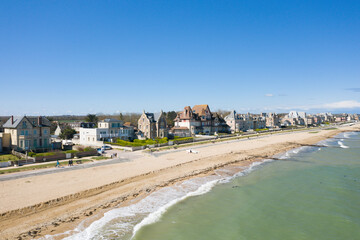 The traditional houses of Sword beach in Lion-sur-Mer in Europe, France, Normandy, towards Ouistreham, in summer, on a sunny day. - obrazy, fototapety, plakaty