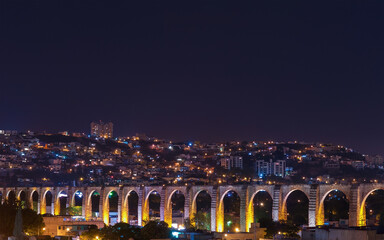 The viaduct of Queretaro city and its skyline at night, Mexico.