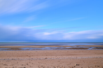 Clouds moving over the Channel Sea in Europe, France, Normandy, Ouistreham, in summer on a sunny day.