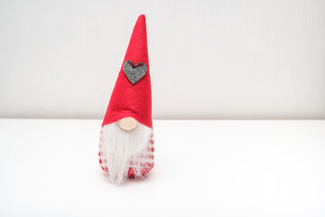 A Christmas elf, gnome, dwarf sitting on a shelf with copy space, holiday ambience atmosphere