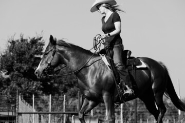 Cowgirl riding horseback for western industry lifestyle portrait.