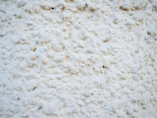 The texture of the white wall in plaster. Uneven  surface