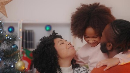 Happy African American family decorating Christmas tree together, holiday season