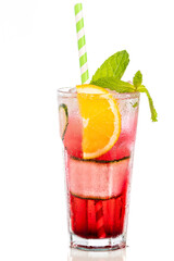 glass with red drink decorated with orange and cucumber on white background.