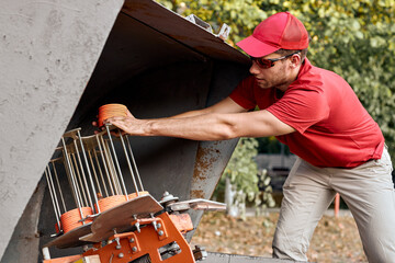 guy use plat machine for shooting-ground training and sporting. Traps machine for shooting-ground...